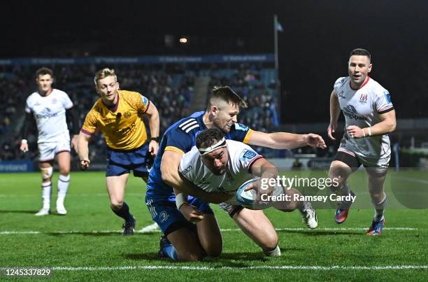 Dublin , Ireland - 3 December 2022; Rob Herring of Ulster dives over to score his side's first try despite the tackle of Ross Byrne of Leinster...