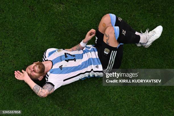 Argentina's midfielder Alejandro Gomez falls during the Qatar 2022 World Cup round of 16 football match between Argentina and Australia at the Ahmad...