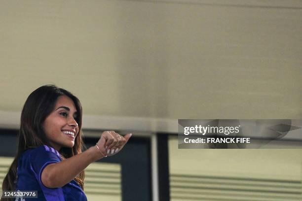 Argentina's forward Lionel Messi's wife, Antonela Roccuzzo waves from the stands during the Qatar 2022 World Cup round of 16 football match between...