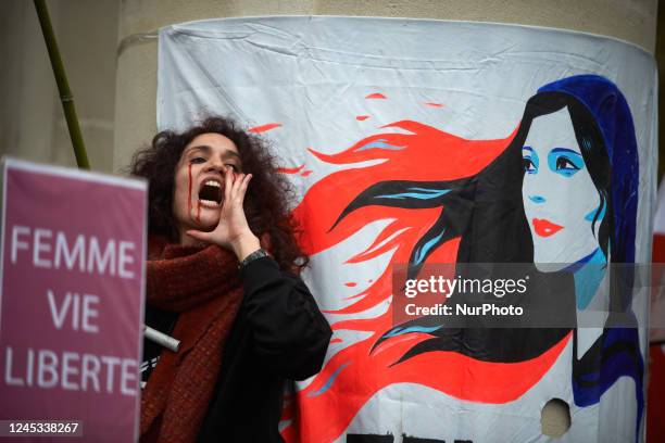 Woman reacts near a drawing depicting Mahsa Amini. Iranians of Toulouse organized a protest in Toulouse in solidarity with women and protesters in...