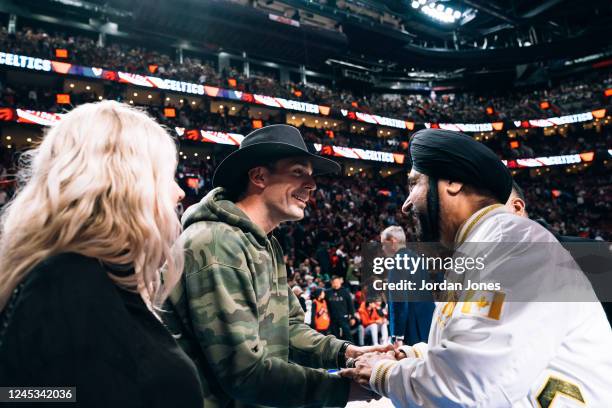 Player Carey Price shakes hands with NBA Superfan Nav Bhatia during a preseason game between the Toronto Raptors and the Boston Celtics on October...