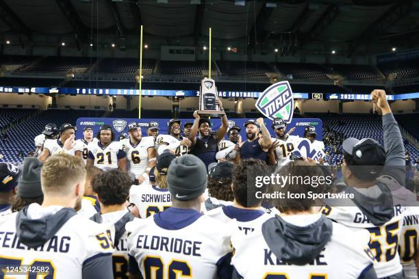 Toledo players celebrate with the championship trophy during the post-game awards ceremony following the Mid-American Conference college football...