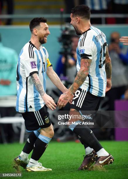 Lionel Messi of Argentina celebrates scoring his goal with Nicolas Otamendi during the FIFA World Cup Qatar 2022 Round of 16 match between Argentina...