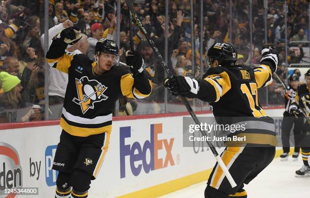 Kasperi Kapanen of the Pittsburgh Penguins celebrates with Bryan Rust after scoring a goal in the first period during the game against the St. Louis...