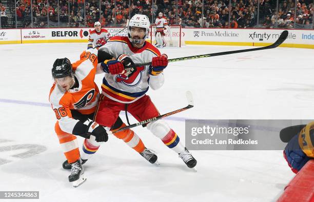 Joel Farabee of the Philadelphia Flyers battles Jonas Siegenthaler of the New Jersey Devils at center ice at the Wells Fargo Center on December 3,...