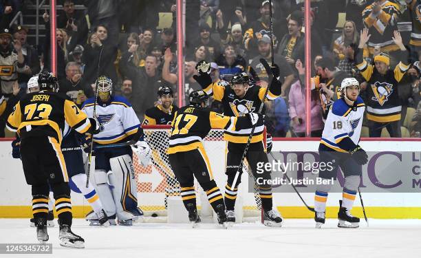 Kasperi Kapanen of the Pittsburgh Penguins celebrates with Bryan Rust after scoring his third goal for a hat trick in the second period of the game...
