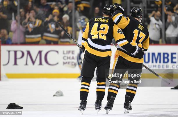 Kasperi Kapanen of the Pittsburgh Penguins celebrates with Bryan Rust after scoring his third goal for a hat trick in the second period of the game...