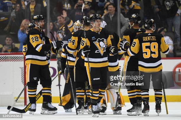 The Pittsburgh Penguins celebrate after a 6-2 win over the St. Louis Blues during the game at PPG PAINTS Arena on December 3, 2022 in Pittsburgh,...