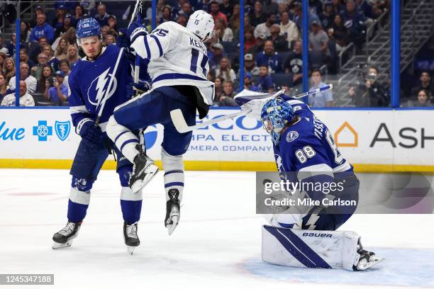 Andrei Vasilevskiy of the Tampa Bay Lightning makes a save past Alexander Kerfoot of the Toronto Maple Leafs as he is defended by Mikhail Sergachev...