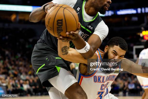 Kenrich Williams of the Oklahoma City Thunder and Naz Reid of the Minnesota Timberwolves compete for the ball in the fourth quarter of the game at...