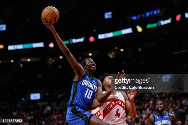 Bol Bol of the Orlando Magic drives to the net against Scottie Barnes of the Toronto Raptors during the first half of their NBA game at Scotiabank...
