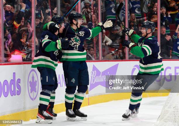 Brock Boeser of the Vancouver Canucks celebrates goal with Ilya Mikheyev and Elias Pettersson during the third period of their NHL game against the...