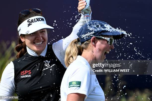 South Africa's Ashleigh Buhai is congratulated by fellow player Hannah Green of Australia after winning the Women's Australian Open golf tournament...