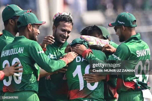 Bangladesh's Shakib Al Hasan celebrates with his teamamtes after the dismissal of India's Virat Kohli during the first one-day international cricket...