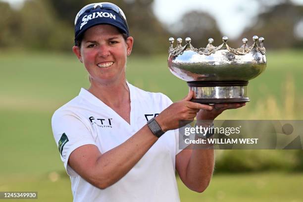 South Africa's Ashleigh Buhai poses with the trophy after winning the women's Australian Open golf tournament at the Victoria course in Melbourne on...