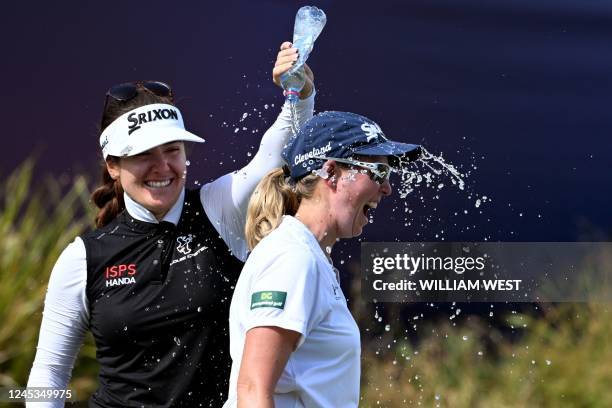 South Africa's Ashleigh Buhai is congratulated by fellow player Hannah Green of Australia after winning the Women's Australian Open golf tournament...