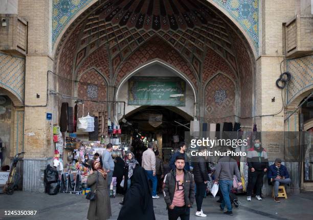 Iranian people walk in front of an entrance of Tehran Grand Bazaar , December 3, 2022.