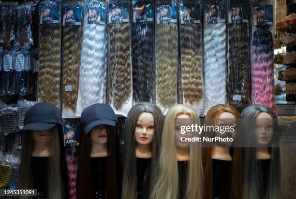 Mannequins are decorated with wigs at a shop in Tehran Grand Bazaar , December 3, 2022.