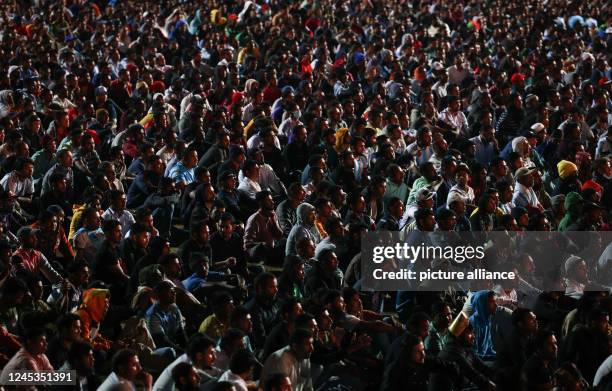 December 2022, Qatar, Doha: Workers, mainly from India, Bangladesh, Nepal and other poorer Asian countries, watch the Argentina-Australia match on a...