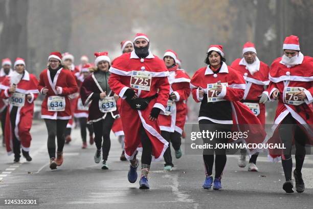 People dressed in Santa Claus costumes take part in the annual christmas run in Michendorf, on December 4, 2022.