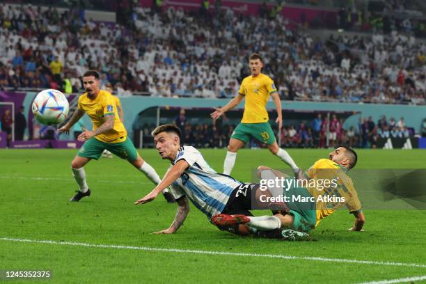 Aziz Behich of Australia sees his shot blocked by Lisandro Martinez of Argentina during the FIFA World Cup Qatar 2022 Round of 16 match between...