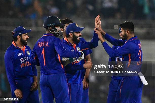 India's cricketers celebrate after the dismissal of Bangladesh's Shakib Al Hasan during the first one-day international cricket match between...