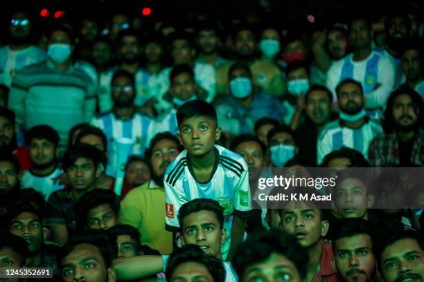 People react when they watch the FIFA world cup 2022 Qatar match between Argentina vs Australia on a big screen in the Dhaka University area.