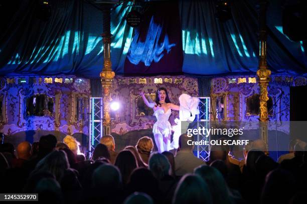 Penny Valent, a member of The Black Cat Cabaret, performs her burlesque routine in The Spiegeltent venue in the centre of the Piece Hall in Halifax,...