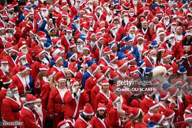 Runners dressed in Father Christmas attire prepare to take part in the annual five-kilometre Santa Dash in Liverpool, northwest England, on December...