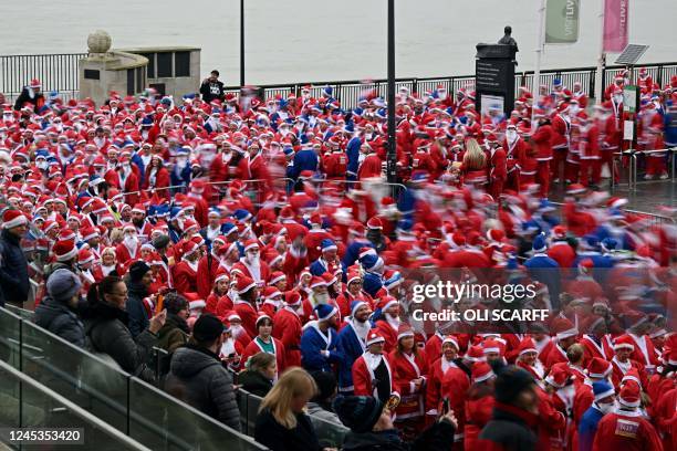 Runners dressed in Father Christmas start the annual five-kilometre Santa Dash in Liverpool, northwest England, on December 4, 2022. - Many runners...