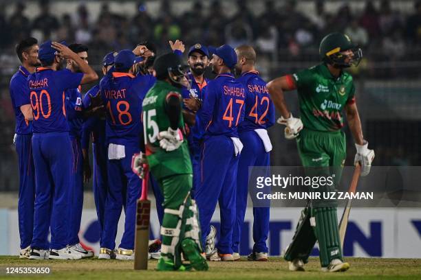 India's cricketers celebrate after the dismissal of Bangladesh's Mahmudullah during the first one-day international cricket match between Bangladesh...