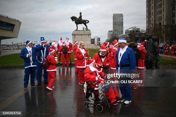 Runners dressed in Father Christmas attire prepare to take part in the annual five-kilometre Santa Dash in Liverpool, northwest England, on December...