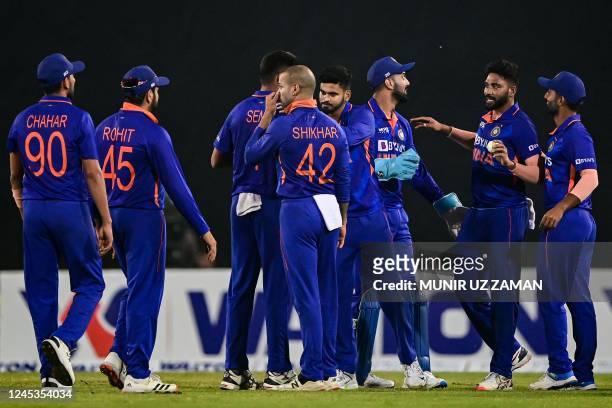 India's cricketers celebrate after the dismissal of Bangladesh's Afif Hossain during the first one-day international cricket match between Bangladesh...