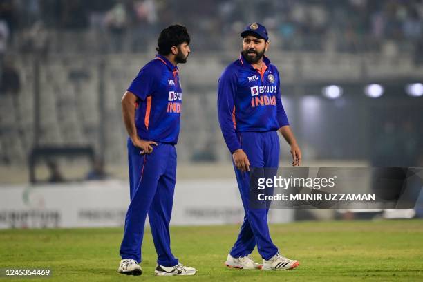 India's Rohit Sharma speaks with teammate Shardul Thakur during the first one-day international cricket match between Bangladesh and India at the...