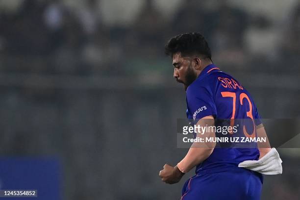 India's Mohammed Siraj reacts after the dismissal of Bangladesh's Hasan Mahmud during the first one-day international cricket match between...