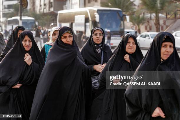 Iranians disembark walk towards a market area for shopping during their visit to Iraq's central holy shrine city of Najaf on December 4, 2022. -...