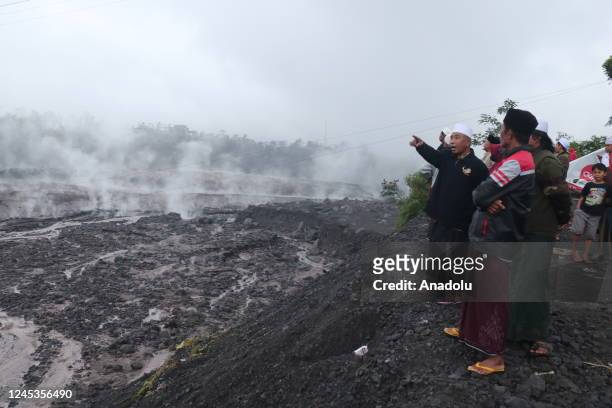 People look at volcanic flow from the eruption of Mount Semeru in Supit Urang village, Lumajang district, East Java Province, Indonesia on December...