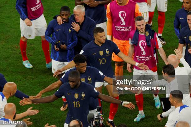 France's forward Kylian Mbappe France's forward Kingsley Coman and France's defender Dayot Upamecano celebrate with teammates at the end of the Qatar...