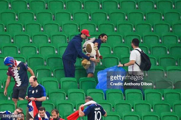 Fans of France cleans the stands during the FIFA World Cup 2022, Round of 16 match between France and Poland at Al Thumama Stadium on December 4,...