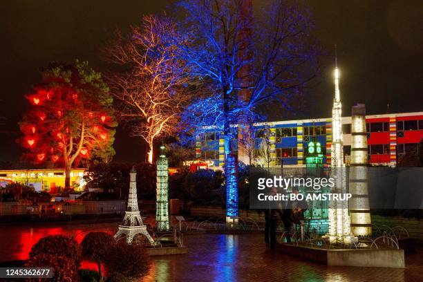 Visitors walk through the illuminated Legoland amusement park in Billund, Denmark on December 4, 2022. - For the first time ever, the amusement park...