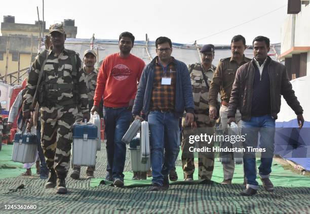 Polling officials with police personnel carrying Electronic Voting Machines for Kudhani Assembly By-Poll in Muzaffarpur, on December 4, 2022 in...