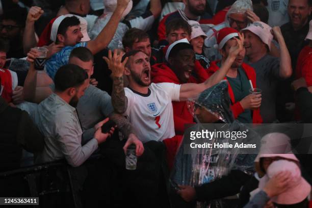 England fans cheer as England score their first goal in their Round of 16 FIFA World Cup match against Senegal at BOXPARK Croydon on December 4, 2022...