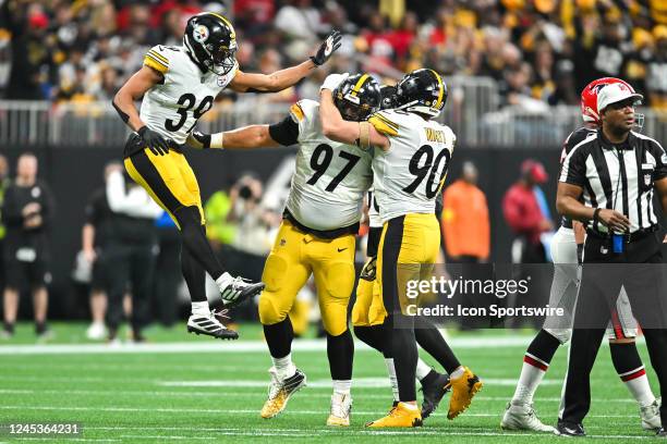 Pittsburgh safety Minkah Fitzpatrick and linebacker T.J. Watt congratulate defensive tackle Cameron Heyward after a defensive stop during the NFL...