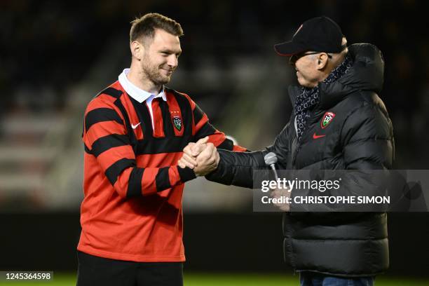 Toulon's Welsh fly-half Dan Biggar shakes hands with RC Toulon's president Bernard Lemaitre prior to the French Top14 rugby union match between RC...