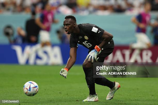 Senegal's goalkeeper Edouard Mendy throws the ball during the Qatar 2022 World Cup round of 16 football match between England and Senegal at the...