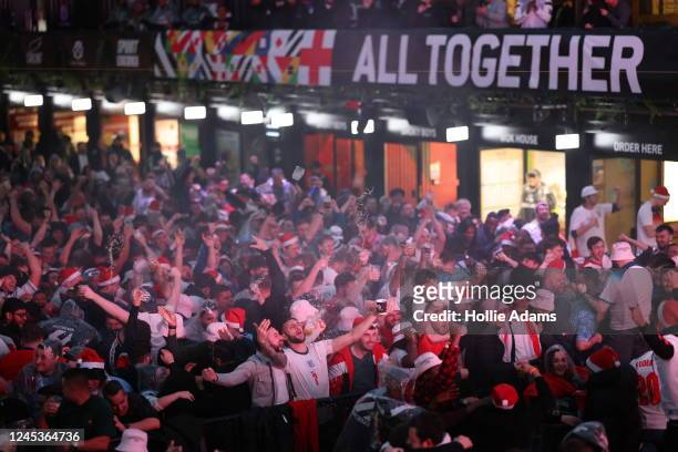 England fans cheer as they watch England score their third goal in their Round of 16 FIFA World Cup match against Senegal at BOXPARK Croydon on...