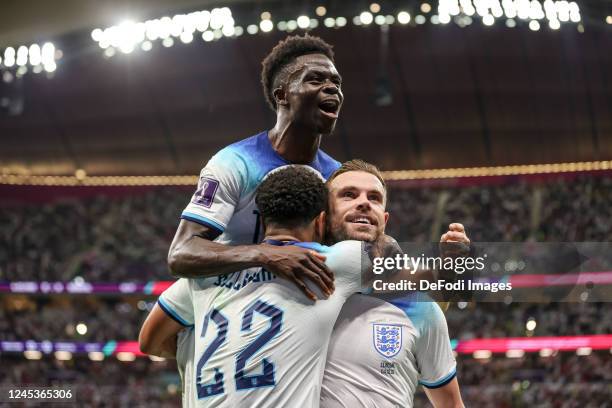 Jordan Henderson of England celebrates after scoring his team's first goal with Jude Bellingham of England and Bukayo Saka of England during the FIFA...