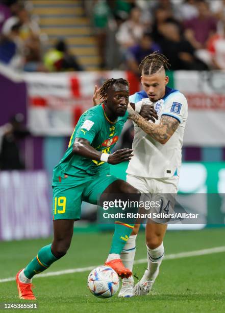 Famara Diedhiou of Senegal and Kalvin Phillips of England challenge during the FIFA World Cup Qatar 2022 Round of 16 match between England and...