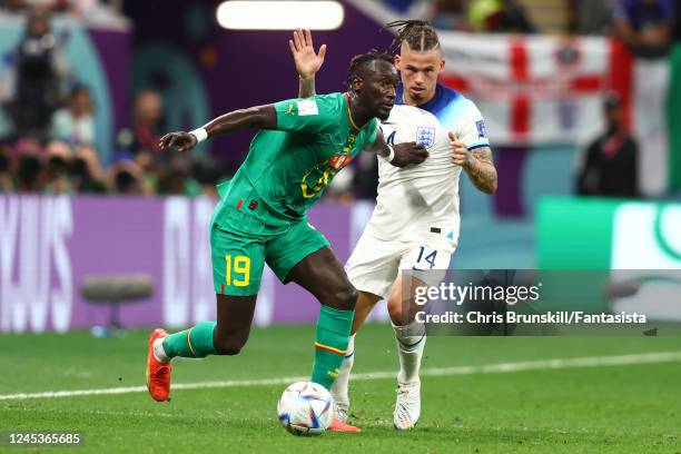 Famara Diedhiou of Senegal competes with Kalvin Phillips of England during the FIFA World Cup Qatar 2022 Round of 16 match between England and...