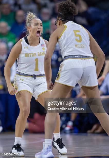 Dara Mabrey of the Notre Dame Fighting Irish and Olivia Miles of the Notre Dame Fighting Irish celebrate during the first half against the UConn...